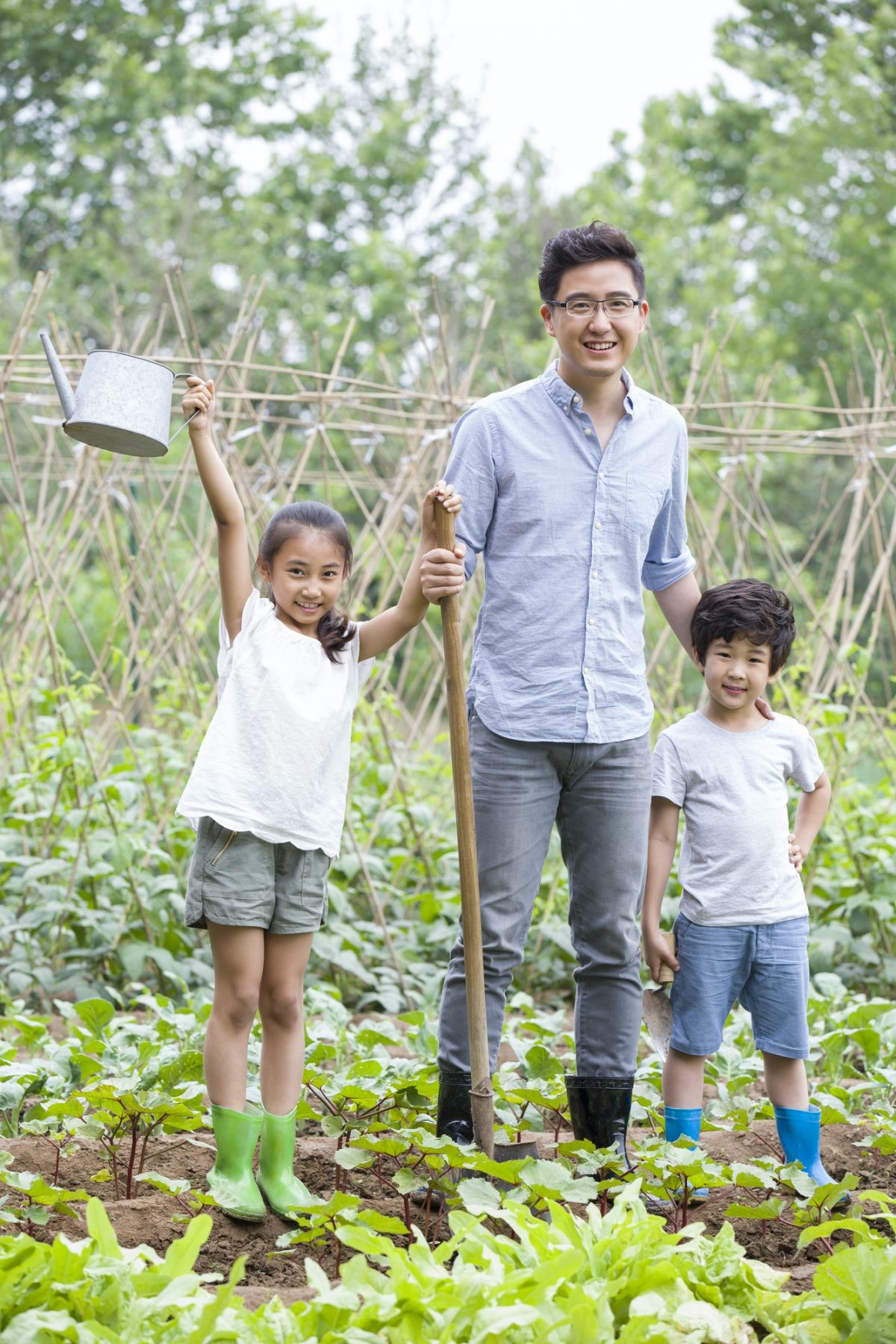 Young father and children gardening together